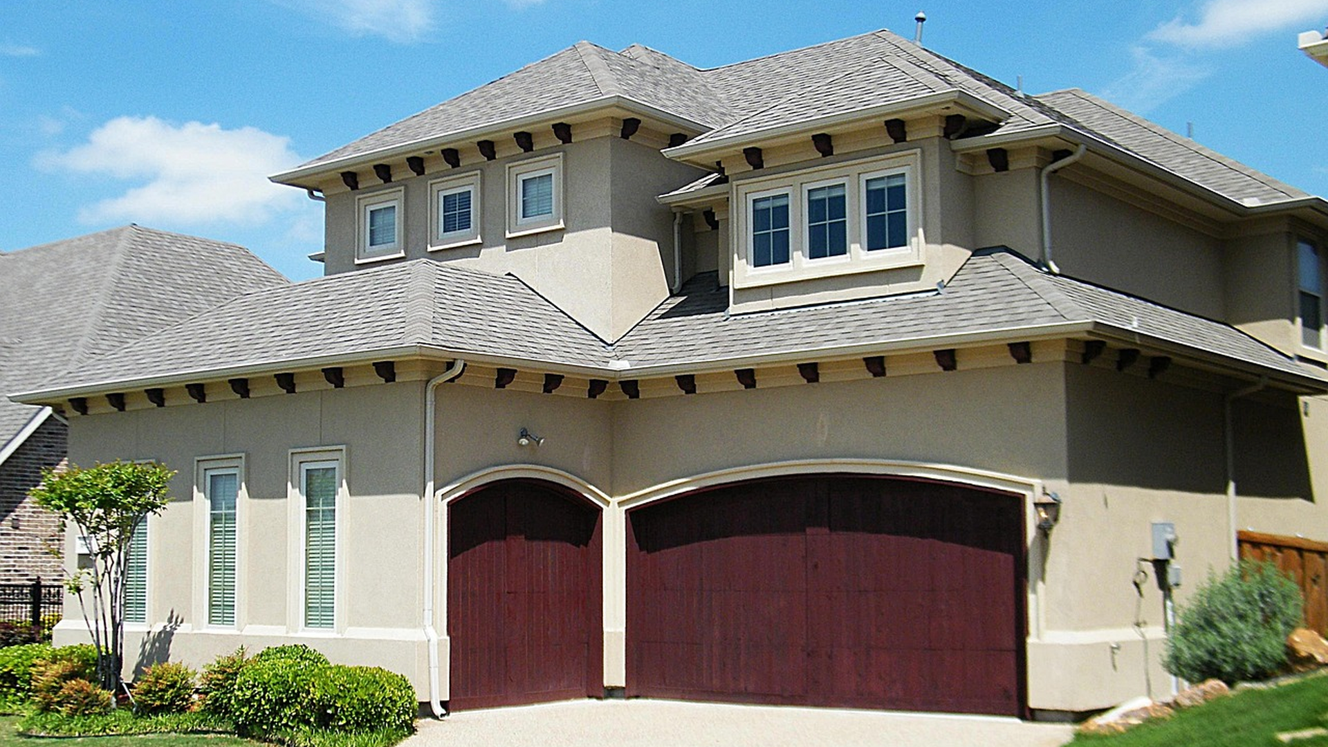 Two-story stucco home with attached garage representing the kind of property a stucco inspection should evaluate