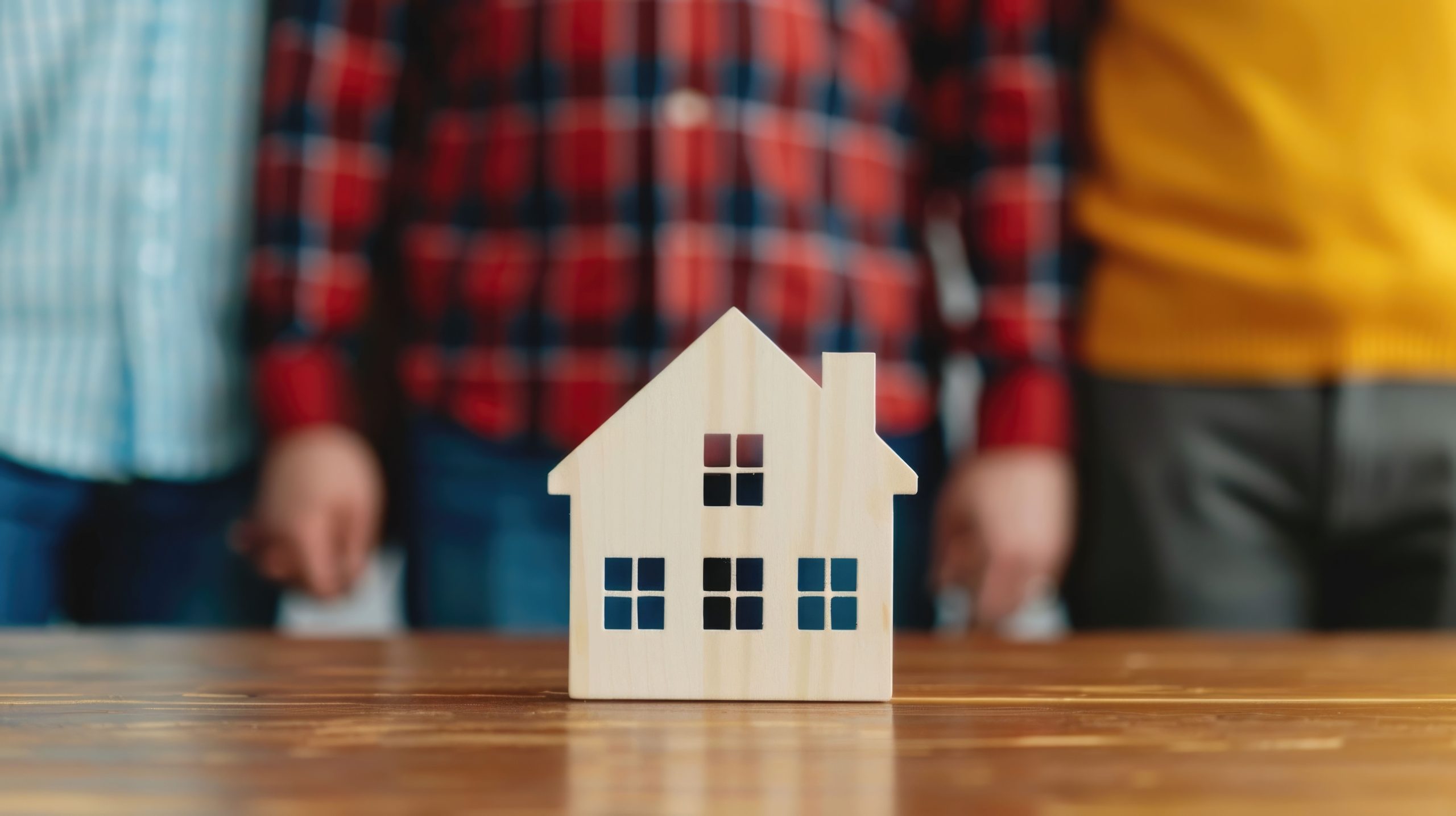 Couple and home inspector reviewing a printed home inspection checklist at a table