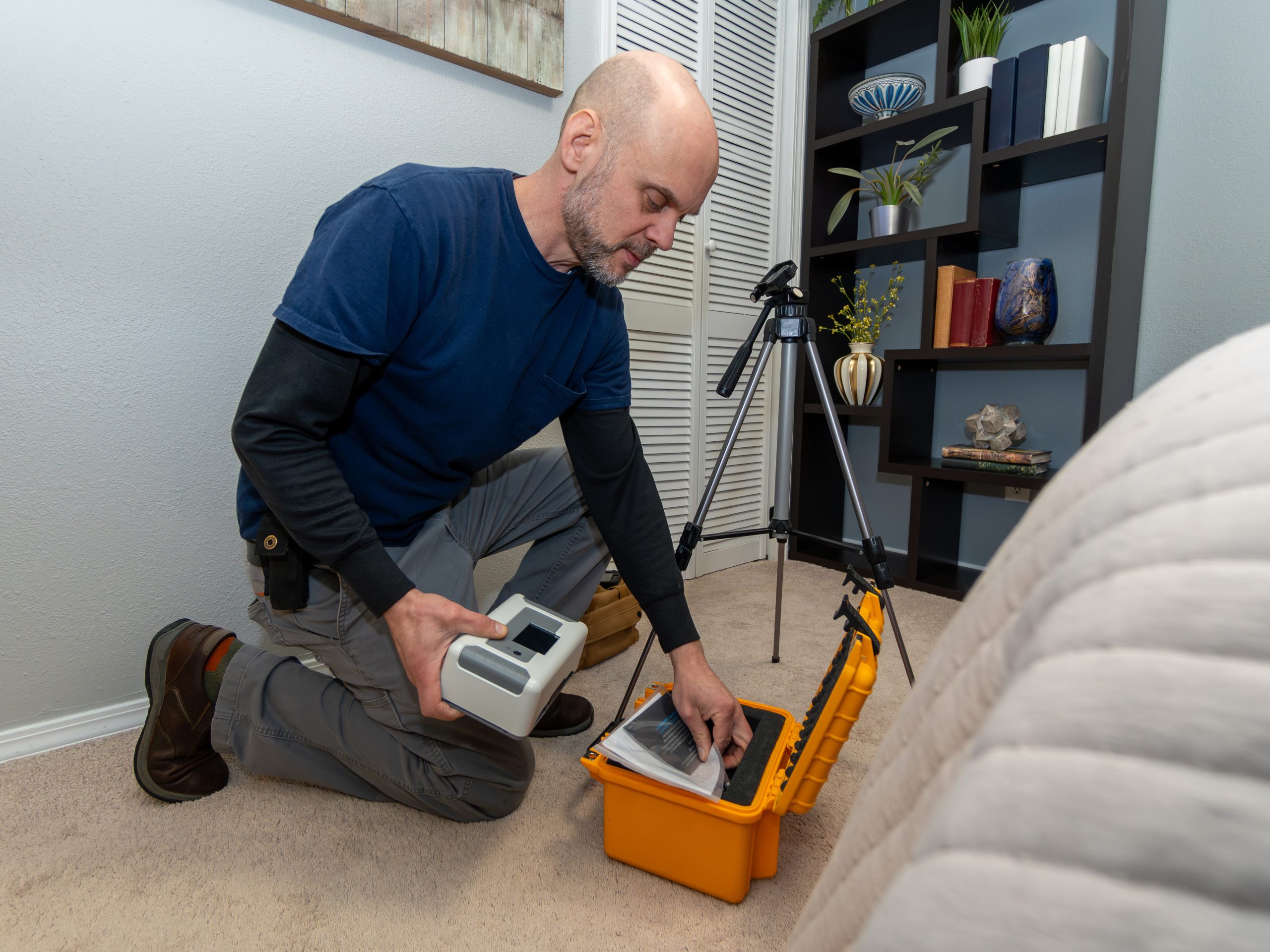 Continuous radon monitor placed in the lowest bedroom of a single-family home during a real estate radon test setup.