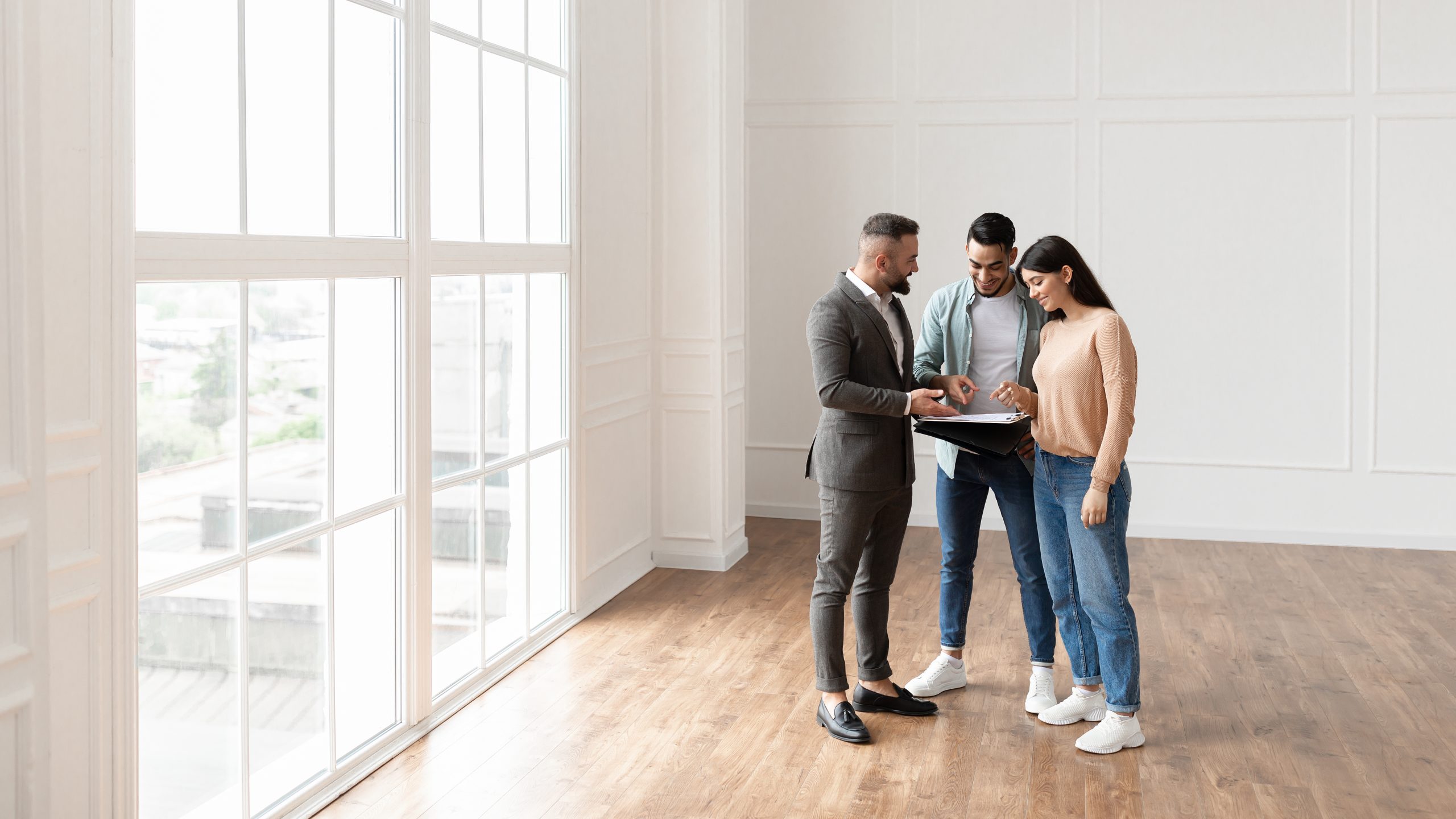 A buyer couple reviewing inspection contingency response details with their real estate agent at a desk in southeast Pennsylvania, going over which repair, credit, or price-adjustment requests to send to the seller inside the contingency window.