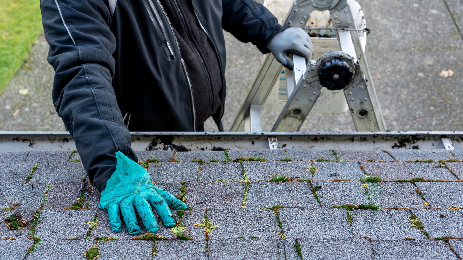 Professional home inspector evaluating the roof of a two-story home