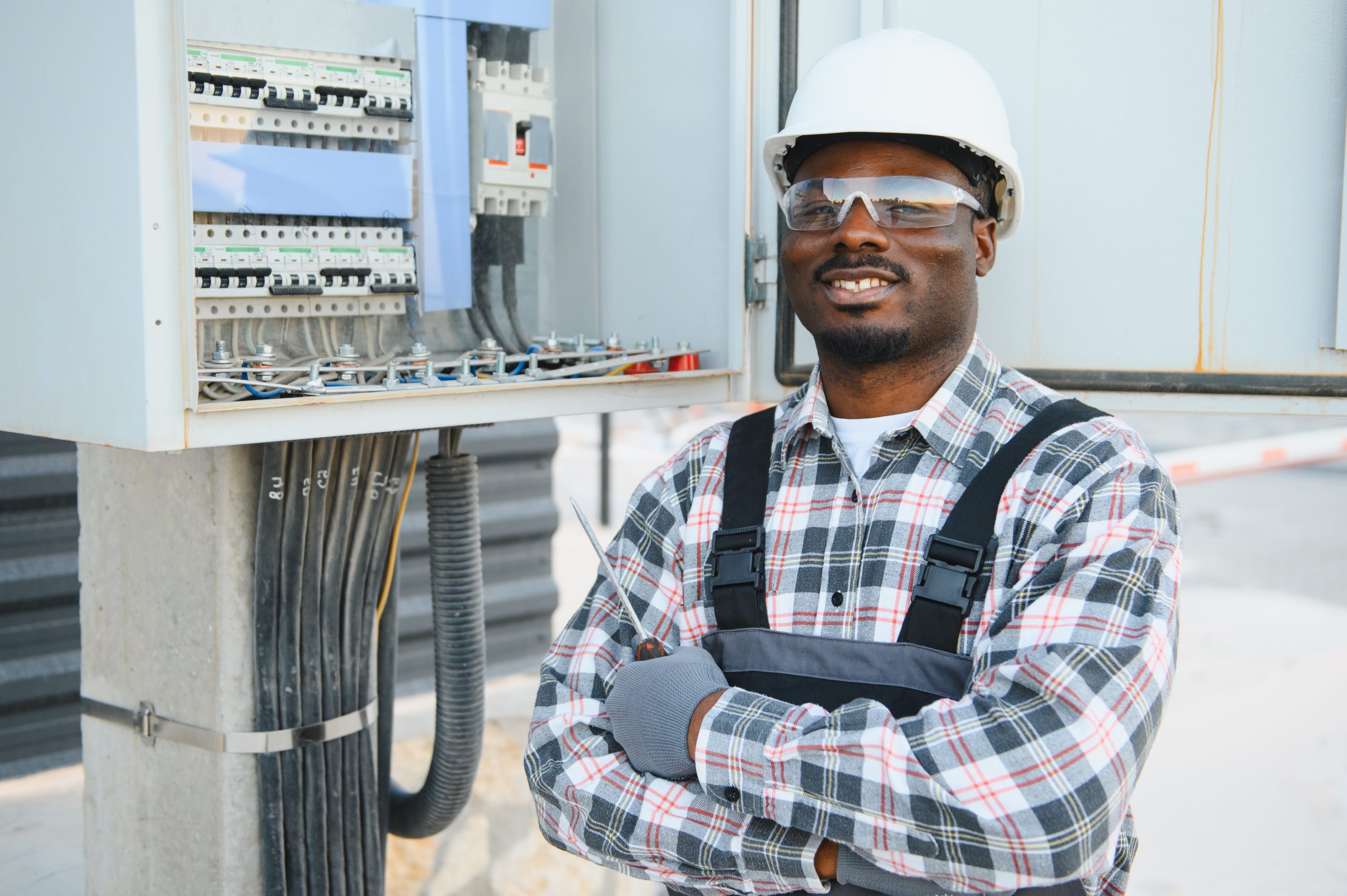 Licensed electrician evaluating the wiring inside an open residential electrical panel during a home inspection