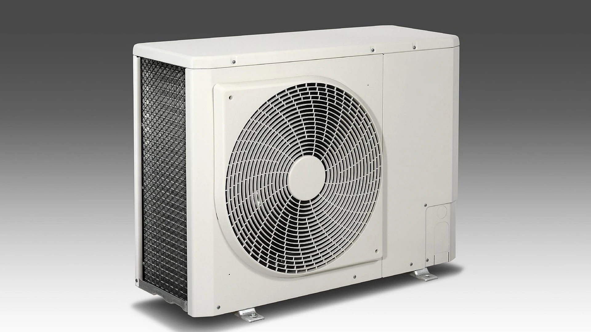 Off-white outdoor air-conditioning condenser unit with a round fan grille and a dark mesh side panel, shown by itself against a gray gradient background
